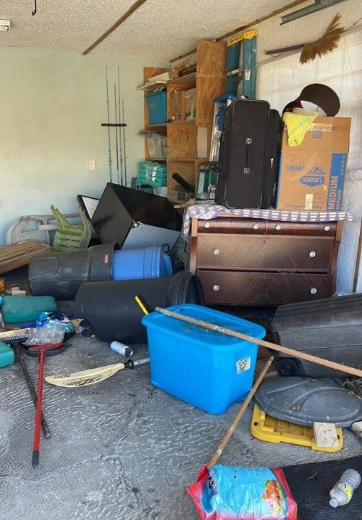 Team hauling junk from basement space